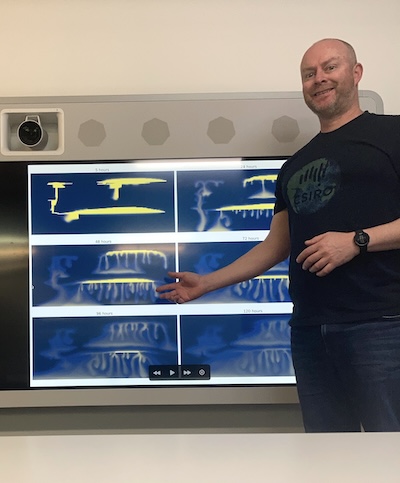 Chris Green presenting charts on a large screen