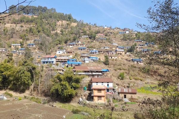 A mountainside dotted with Nepalese-style dwellings