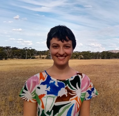 Elena Tartaglia, standing in a golden plain of grass