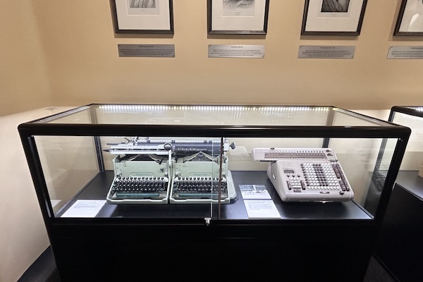 A display case filled with old mathematical instruments
