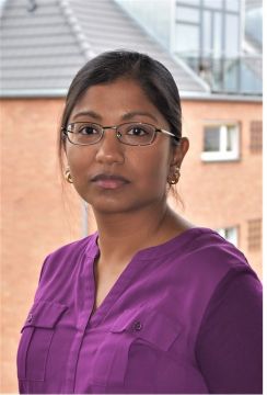 Profile photo of Aru wearing a purple top and glasses