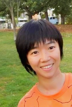Portrait of smiling person with short black hair
