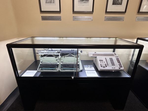 Display case showing a mathematics dual typewriter and electromechanical calculator